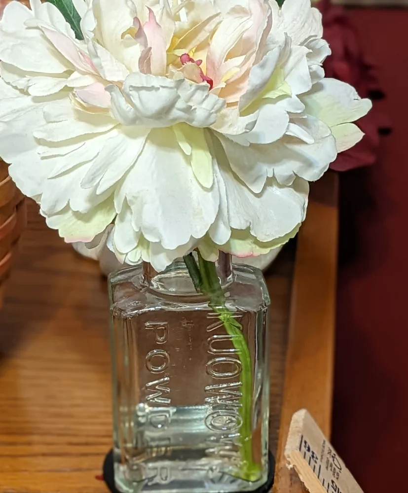 Beautiful faux flower in vintage container